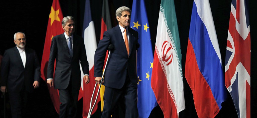 U.S. Secretary of State John Kerry, centre British Foreign Secretary Philip Hammond, centre and Iranian Foreign Minister Mohammad Javad Zarif arrive for a group picture at the Vienna International Center in Vienna, Austria, Tuesday, July 14, 2015.