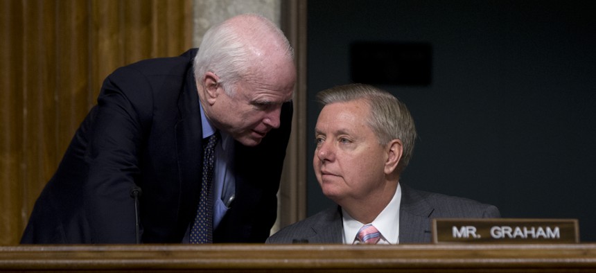 Senate Armed Services Committee Chairman Sen. John McCain, R-Ariz., left, speaks with Sen. Lindsey Graham, R-S.C., during the Senate Armed Services Committee hearing on Capitol Hill in Washington, Tuesday, July 7, 2015.