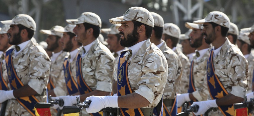 In this Sept. 22, 2011 photo, members of Iran's Revolutionary Guard march in front of the mausoleum of the late Iranian revolutionary founder Ayatollah Khomeini, just outside Tehran, Iran.