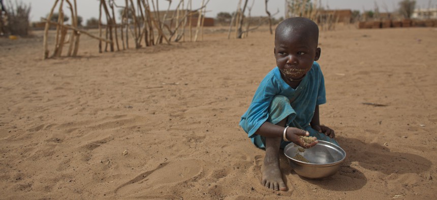 A 2 year old child eats dry couscous in the village of Goudoude Diobe, Senegal., on May 1, 2012.