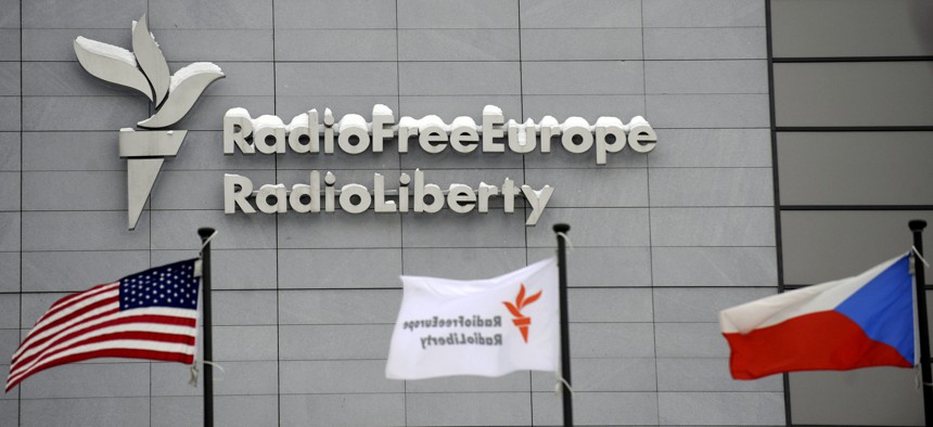 The headquarters of Radio Free Europe/Radio Liberty (RFE/RL) seen with the United States, RFE/RL and the Czech Republic flags in the foreground, in Prague Friday, Jan. 15, 2010.