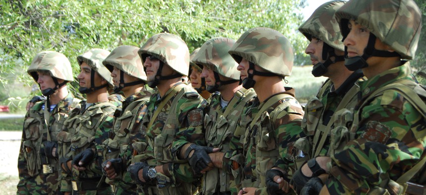 Tajikistani soldiers form a human barricade while conducting riot control operations during Steppe Eagle 2013 at the Iliskiy Training Center in the Almaty region of Kazakhstan, Aug. 13, 2013. 