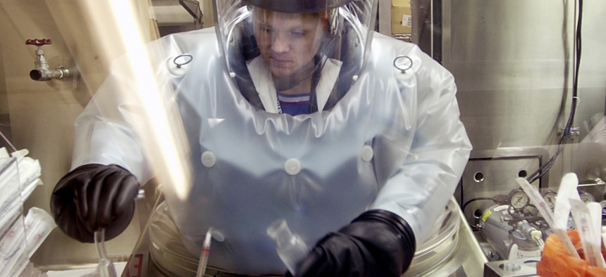 In this May 11, 2003, file photo, Microbiologist Ruth Bryan works with BG nerve agent simulant in Class III Glove Box in the Life Sciences Test Facility at Dugway Proving Ground, Utah.