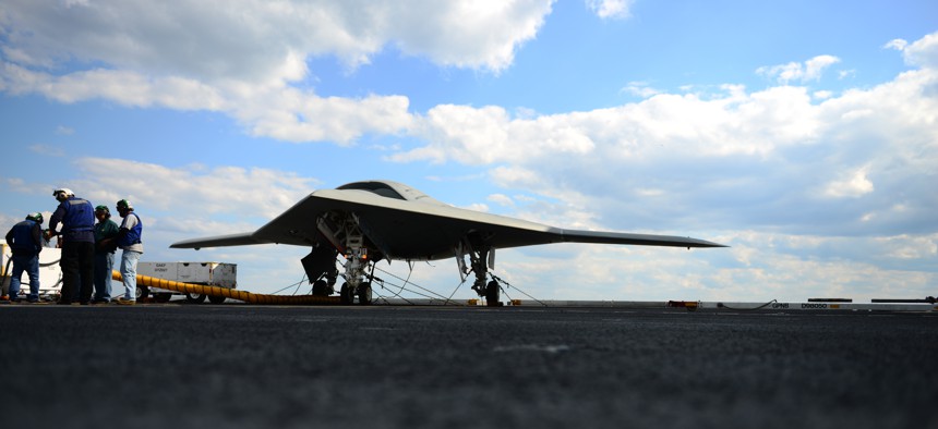Northrop Grumman personnel conduct pre-operational tests on an X-47B Unmanned Combat Air System demonstrator on the flight deck of the aircraft carrier USS George H.W. Bush, on May 13, 2013.