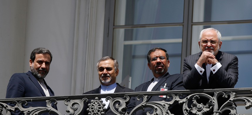 Iranian Foreign Minister Mohammad Javad Zarif reacts as he stands on a balcony with other members of his delegation outside of the current round of Iran nuclear talks, being held in Vienna, Austria July 10, 2015.