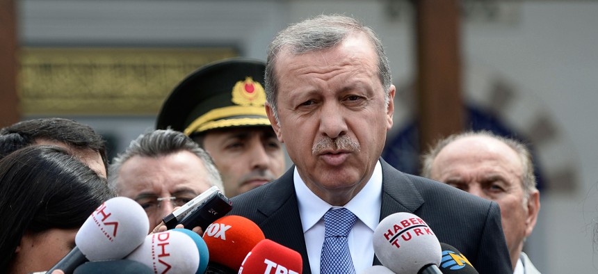 Turkish President Recep Tayyip Erdogan speaks to the media in front of a mosque in Istanbul, Turkey, Friday, July 24, 2015.