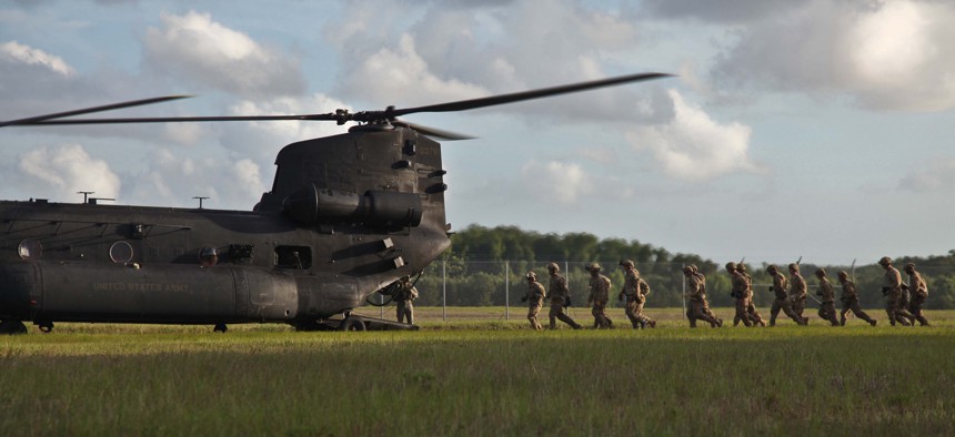 Army Rangers of 1st Battalion, 75th Ranger Regiment, prepare to enter an MH-47 helicopter to execute fast rope training at Hunter Army Airfield, Ga. June 2, 2014. 