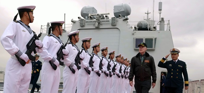 Chinese sailors render honors to Secretary of the Navy (SECNAV) the Honorable Ray Mabus during a visit to the People's Liberation Army Navy hospital ship Peace Ark.
