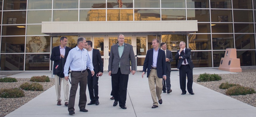 Deputy Defense Secretary Robert Work walks with defense officials outside of the Pentagon's Defense Innovation Unit-Experimental in Silicon Valley.