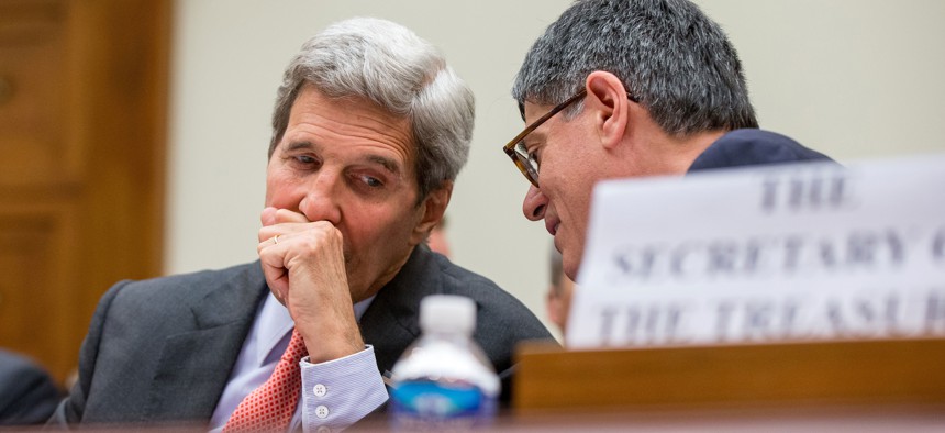 Secretary of State John Kerry, left, speaks with Treasury Secretary Jacob Lew, as they testify on Capitol Hill in Washington, July 28, 2015.