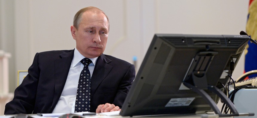 Russian President Vladimir Putin attends a video conference on commissioning military products in the situation center in the Kremlin in Moscow, Russia, Thursday, July 16, 2015.