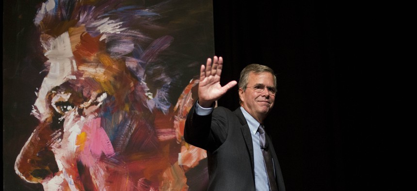 Republican presidential candidate Jeb Bush waves to the crowd while walking past a portrait of former President Ronald Reagan after speaking at the RedState Gathering Saturday, Aug. 8, 2015, in Atlanta. 
