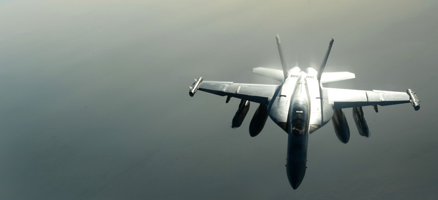 A U.S. Navy EA-18G Growler waits to be refueled by a U.S. Air Force KC-135 Stratotanker over Southwest Asia in support of Operation Inherent Resolve, Aug. 20, 2015. 