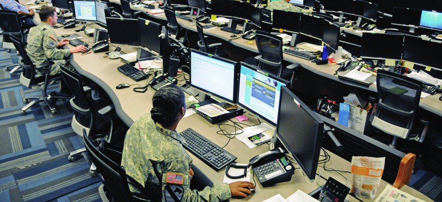 Uniformed and civilian cyber and military intelligence specialists monitor Army networks at Fort Gordon, Ga.
