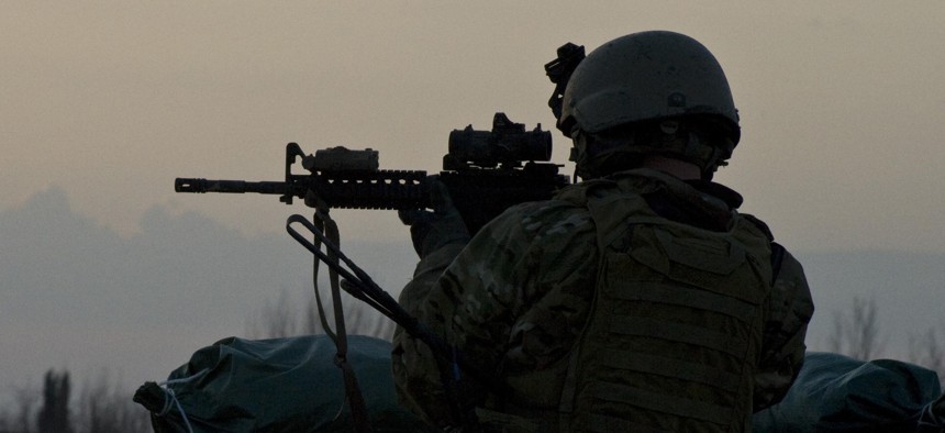 A U.S. Army military information support operations sergeant with Special Operations Task Force-South provides security overwatch in Kandahar province's Zharay District in Afghanistan in 2011.