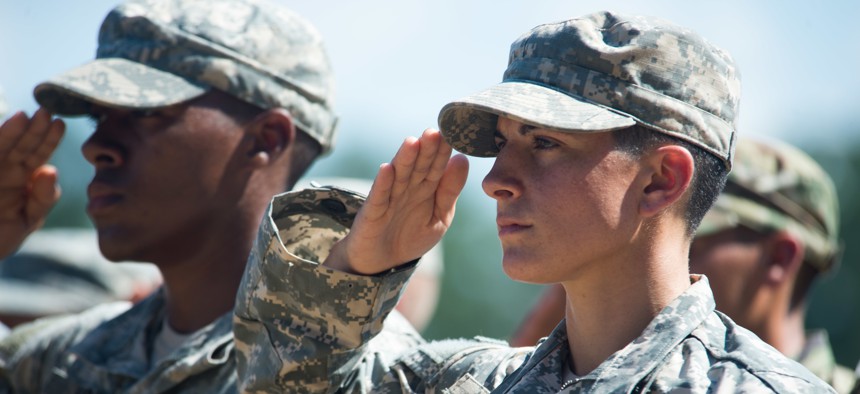 Capt. Kristen Griest and U.S. Army Ranger School Class 08-15 render a salute during their graduation at Fort Benning, Ga., Aug. 21, 2015. Griest and class member 1st Lt. Shaye Haver became the first female graduates of the school.