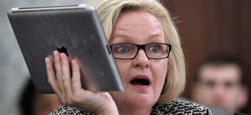 Sen. Claire McCaskill, D-Mo., holds up her Apple IPad during a hearing of the Subcommittee on Consumer Protection, Product Safety, and Insurance on cell phone privacy on Capitol Hill Thursday, May 19, 2011 in Washington. 