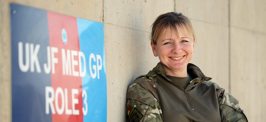 A Royal Army Reserves Cultural Specialist officer at one of the Afghan National Army (ANA) hospital wards at Camp Shorabak, Helmand Province, Afghanistan, in 2014.