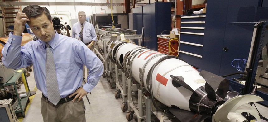 Christopher Del Mastro, head of anti submarine warfare mobil targets stands next to an unmanned underwater vehicle (UUV) in a lab at the Naval Undersea War Center in Middletown, RI., Tuesday, July 31, 2012. 