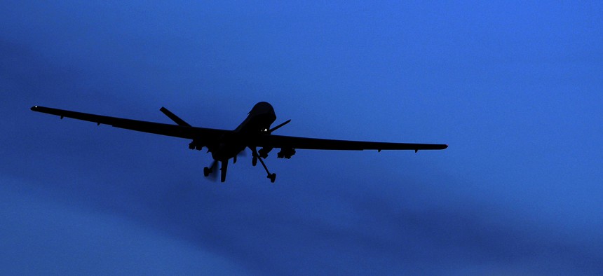 An unmanned U.S. Predator drone flies over Kandahar Air Field, southern Afghanistan, on a moon-lit night, Jan. 31, 2010.