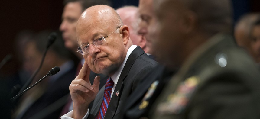 Director of National Intelligence James Clapper listens at center to testimony given by Director of the Defense Intelligence Agency, Lt. Gen. Vincent Stewart, far right, during a House Intelligence Committee hearing.