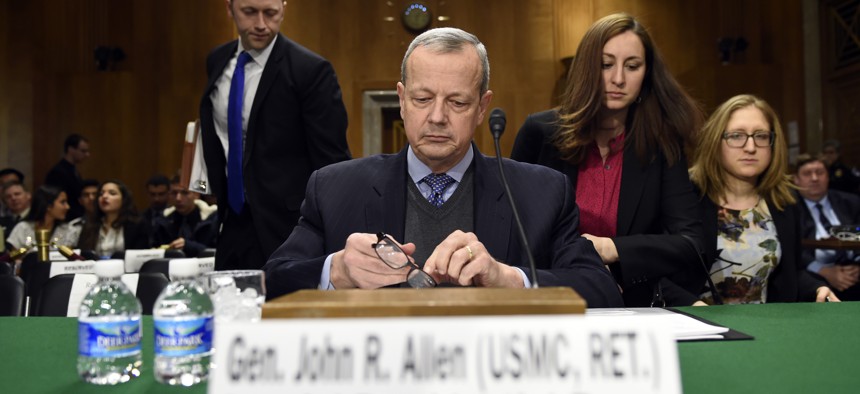 Special Presidential Envoy for the Global Coalition to Counter IS, retired Gen. John R. Allen prepares to testify on Capitol Hill, Feb. 25, 2015, before the Senate Foreign Relations Committee.