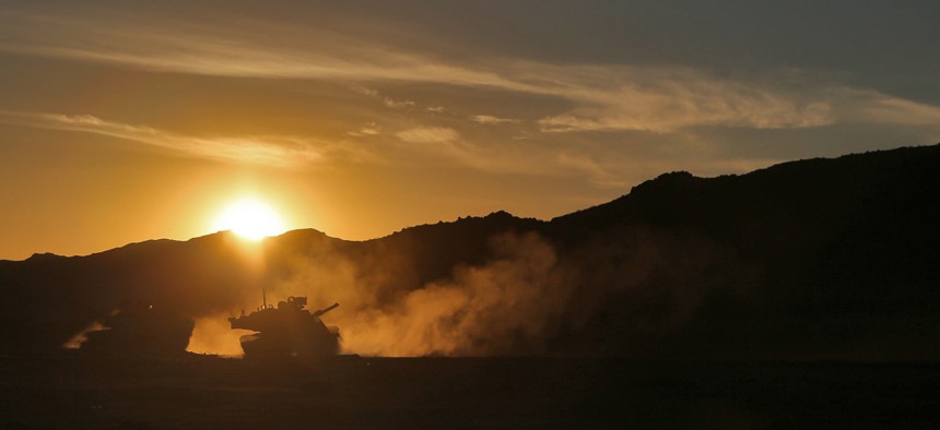 U.S. Army Soldiers, assigned to the Arkansas National Guard, pass through a breach cleared by a Mine Clearing Line Charge during Decisive Action Rotation 15-09 at the National Training Center, Fort Irwin, Calif. Aug. 16, 2015.