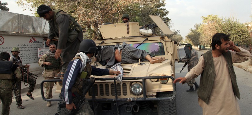 Afghan security forces take a wounded civilian man to the hospital after Taliban fighter's attack, in Kunduz city, north of Kabul, Afghanistan, Saturday, Oct. 3, 2015.