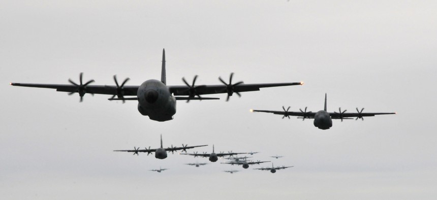 C-130J Hercules and WC-130J Hercules fly in formation during an Operation Surge Capacity exercise April, 5, 2014, over the Mississippi Gulf Coast region.