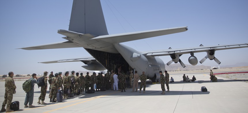 In this Tuesday, Aug. 18, 2015 photo, Afghan National Army soldiers line up to get into a C-130 Hercules, at Kandahar Air Base, in Kandahar, Afghanistan.