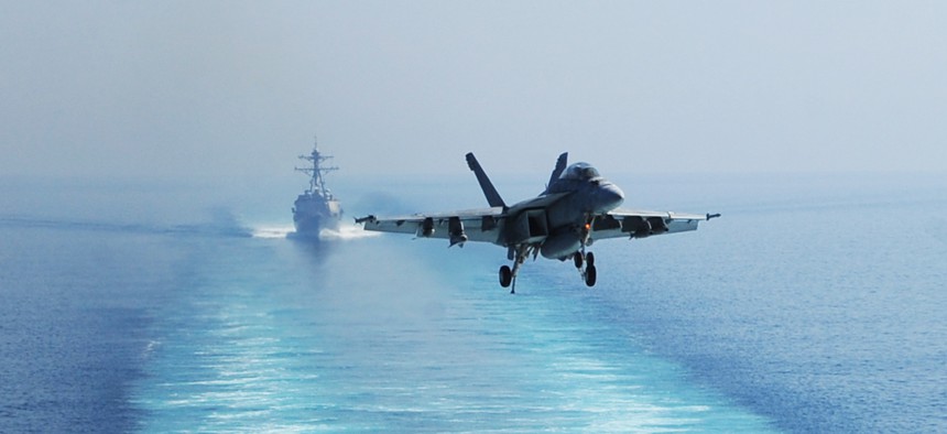 A U.S. Navy F/A-18F Super Hornet aircraft prepares to land on the flight deck of the aircraft carrier USS George H.W. Bush (CVN 77), not shown, in the Persian Gulf Oct. 3, 2014, in operations against the Islamic State in Iraq and Syria.