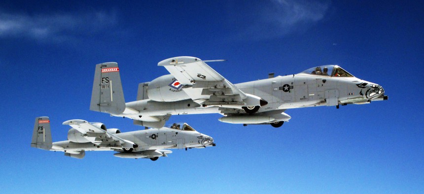 A pair of Air Force A-10 Thunderbolt II aircraft fly in formation June, 7, 2014 over Kansas.
