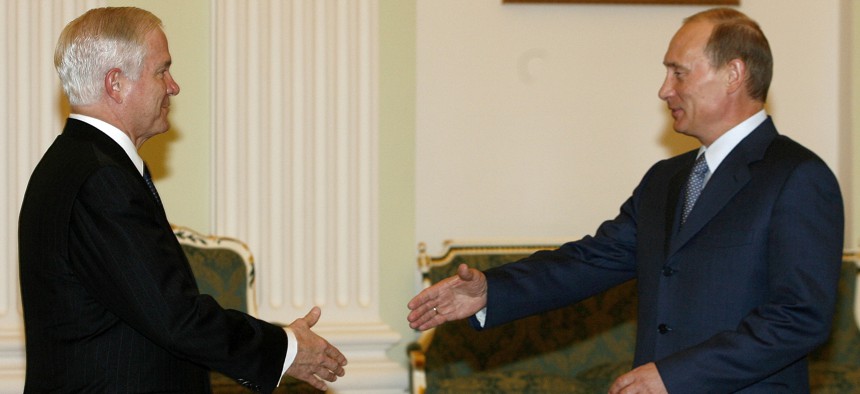 U.S. Defense Secretary Robert Gates and Russian President Vladimir Putin, right, smile and shake hands in Moscow's Kremlin on Monday, April 23, 2007.