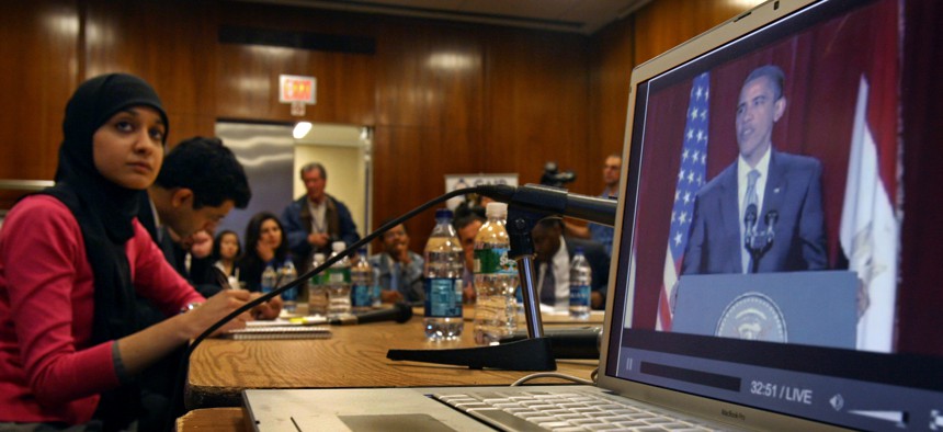 aiza Ali, Council on American-Islamic Relations (CAIR) community affairs director, watches U.S. President Barack Obama's speech from Cairo projected on a big screen off a laptop computer with New York area Muslim leaders at the InterChurch Center in New Y
