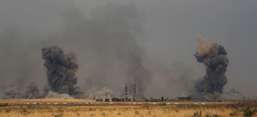 Smoke rises during a military operation launched by Kurdish troops known as peshmerga to regain control of some villages from Islamic State group west of the oil-rich city of Kirkuk, 180 miles (290 kilometers) north of Baghdad, Iraq, Sept. 30, 2015.