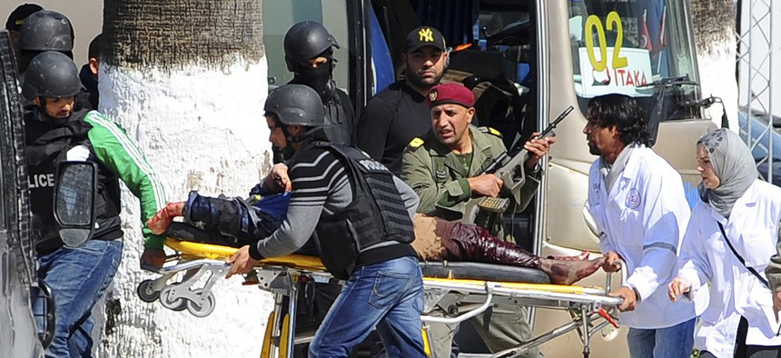 A victim is evacuated by rescue workers outside the Bardo museum in Tunis, Tunisia, on March 18, 2015.