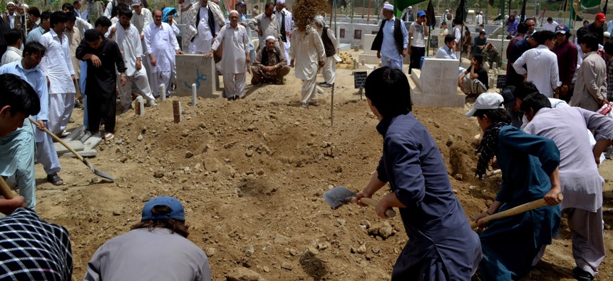 People bury victims of a suicide bombing in Quetta, Pakistan, Monday, July 1, 2013. The militant group Lashkar-e-Jhangvi, which has carried out many attacks against Shiites in recent years, claimed responsibility.