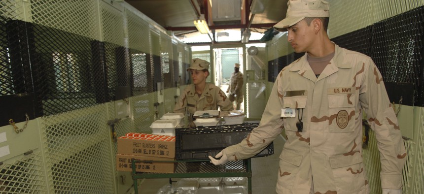 Joint Task Force Guantanamo, Guantanamo Bay, Cuba (13 Feb 2006)- A U.S. Navy Masters at Arms deliver lunch to detainees in Camp Delta.