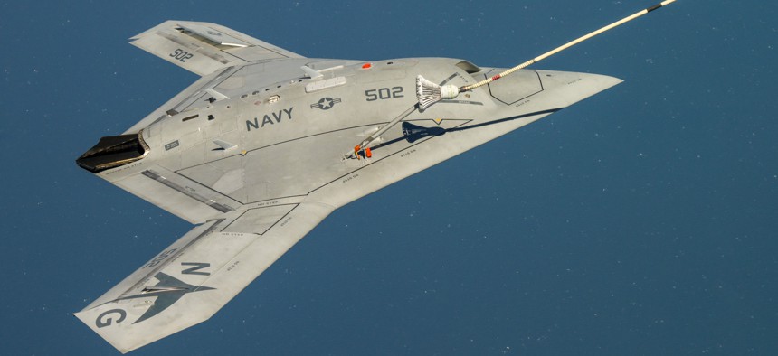 The Navy's unmanned X-47B receives fuel from an Omega K-707 tanker while operating in the Atlantic Test Ranges over the Chesapeake Bay. This test marked the first time an unmanned aircraft refueled in flight.
