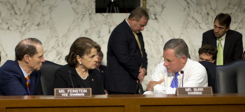 Senate Intelligence Committee Chairman Sen. Richard Burr, R-N.C., right, confers with committee Vice-Chair. Sen. Dianne Feinstein, D-Calif., center, and committee member Sen. Ron Wyden, D-Ore., on Capitol Hill, Thursday, Sept. 24, 2015.