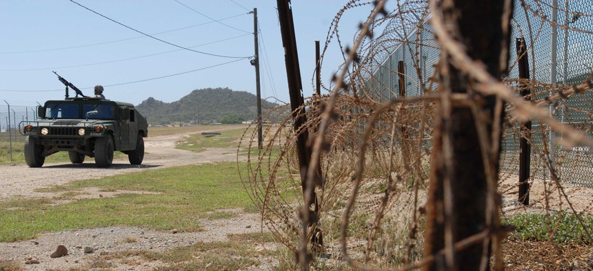 A Humvee from the Puerto Rico Army National Guard's, 480th Military Police Company, patrols the perimeter of the detention facility at Guantanamo Bay Naval Base, Cuba.