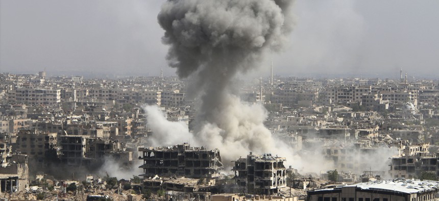In this photo taken on Wednesday, Oct. 14, 2015, smoke rises after shelling by the Syrian army in Jobar, Damascus, Syria.