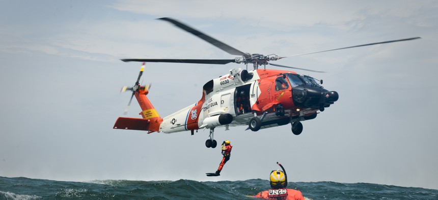 Rescue swimmers and aircrewmen from Coast Guard Air Station Cape Cod, Mass., conduct hoist training evolutions June 23, 2015. 