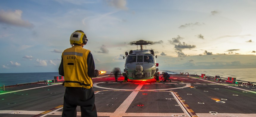 SOUTH CHINA SEA (April 30, 2015) Sailors assigned to LCS Crew 103 chock and chain an MH-60R Seahawk helicopter, from Helicopter Maritime Strike Squadron (HSM) 35, on the flight deck aboard the littoral combat ship USS Fort Worth (LCS 3).