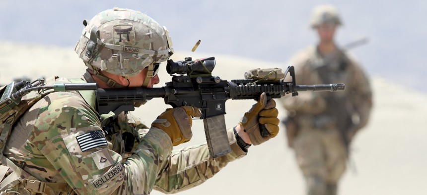 A U.S. Army Soldier, assigned to 3rd Brigade Combat Team, 101st Airborne Division, fires an M4 carbine rifle during partnered live fire range training at Tactical Base Gamberi, Afghanistan, May 29, 2015.
