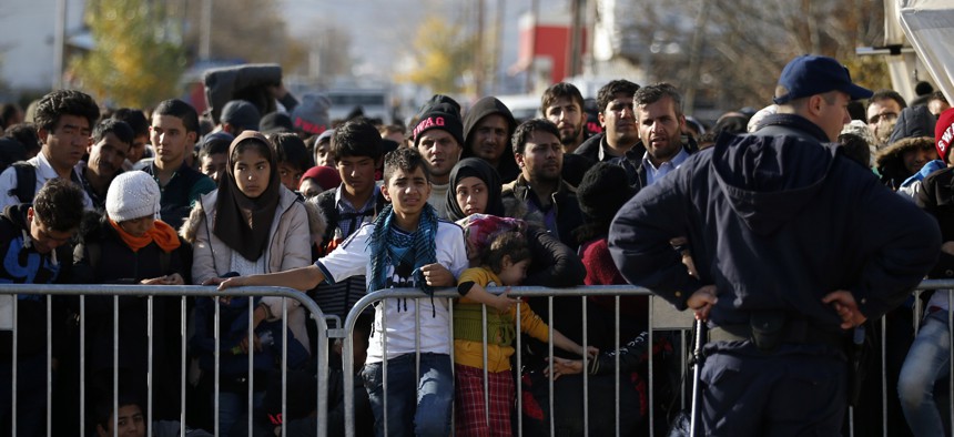 Migrants wait to register with the police at the refugee center in the southern Serbian town of Presevo, Monday, Nov. 16, 2015. 