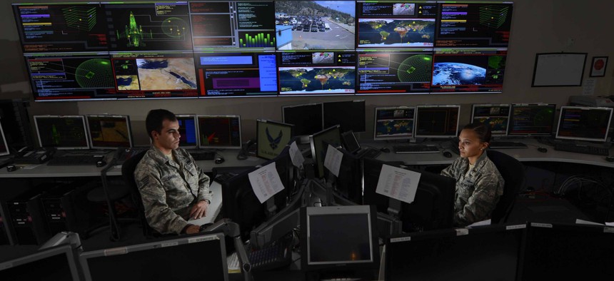 Staff Sgt. Alex Garviria and 2nd Lt. Rachel James work in the Global Strategic Warning and Space Surveillance System Center Sept. 2, 2014, at Cheyenne Mountain Air Force Station, Colo.