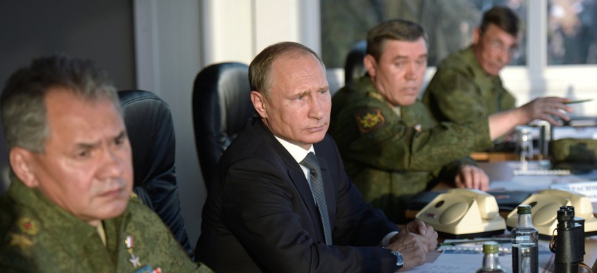 Russian President Vladimir Putin, second left, flanked by Defense Minister Sergei Shoigu, left, and Chief of the General Staff of the Russian Armed Forces Valery Gerasimov.