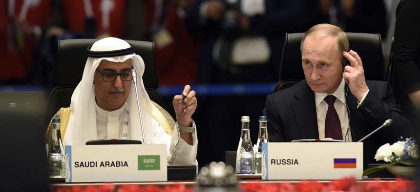 Saudi minister of finance Ibrahim bin Abdulaziz Al-Assaf, left, and Russia’s President Vladimir Putin attend a working session at the G-20 Summit in Antalya, Turkey, Sunday, Nov. 15, 2015.