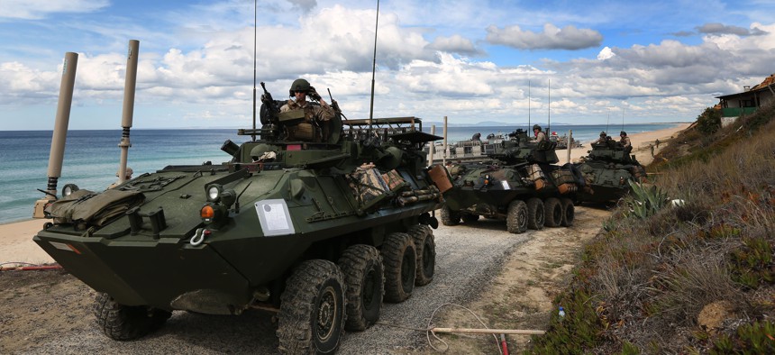 US marine armoured vehicles leave the beach after getting off from US Navy hovercrafts during the NATO Trident Juncture exercise 2015 at Raposa Media beach in Pinheiro da Cruz, south of Lisbon, Tuesday, Oct. 20, 2015. 